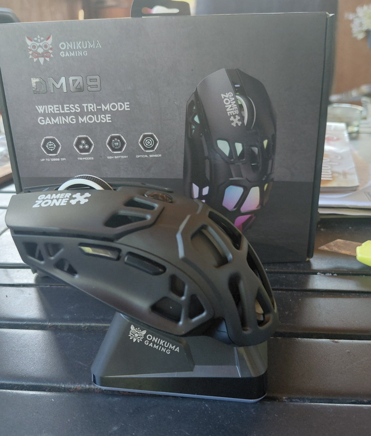 ONIKUMA DM09 gaming mouse docked upright on its magnetic charging stand