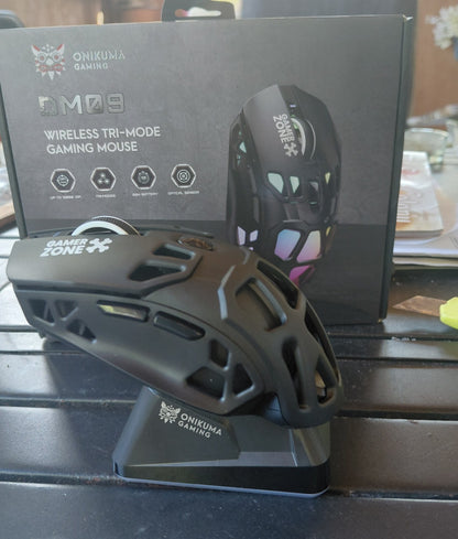 ONIKUMA DM09 gaming mouse docked upright on its magnetic charging stand